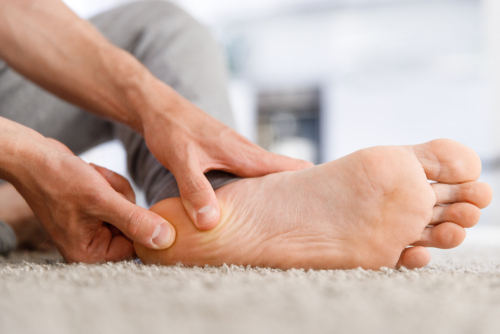 Man,Hands,Giving,Foot,Massage,To,Yourself,After,A,Long Man suffering from plantar fasciitis