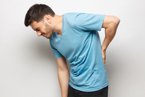 Young,Unhappy,Guy,In,Blue,T-shirt,Suffering,From,Severe,Backache, Man with back ache