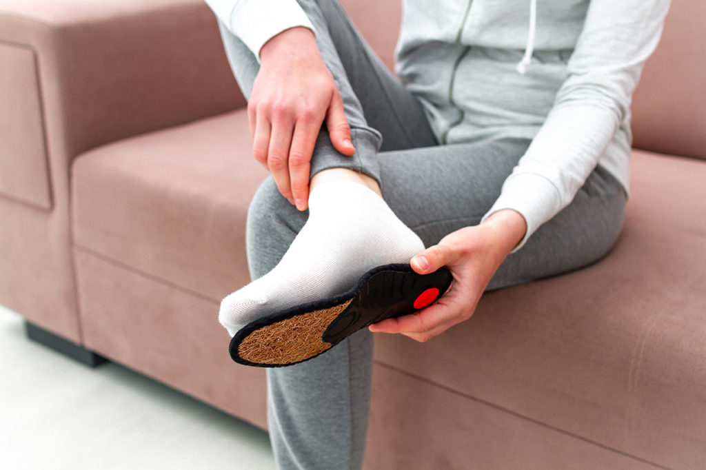 Woman with orthotic insoles for foot pain