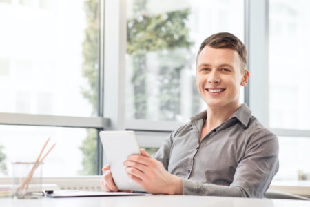 Cheerful,Man,Holding,Tablet Cheerful man holding tablet