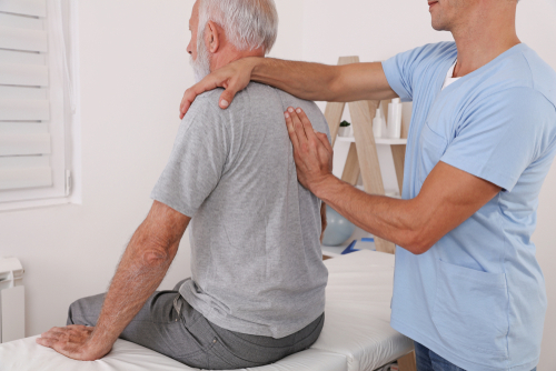 Older man with physical therapist