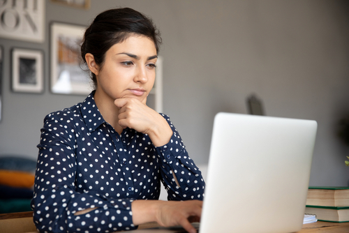 woman using laptop to research medical conditions