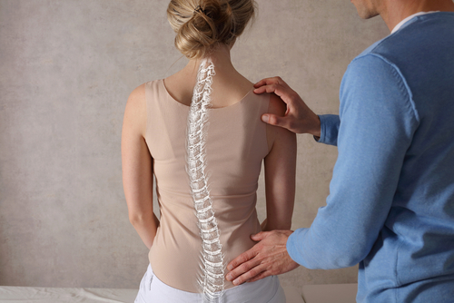 Woman with scoliosis and physical therapist
