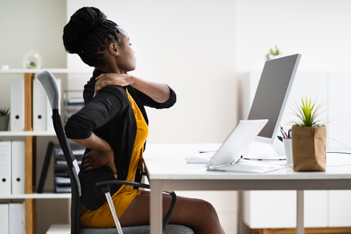 Woman at desk with back pain