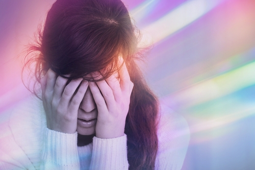 Woman experiencing migraine with aura